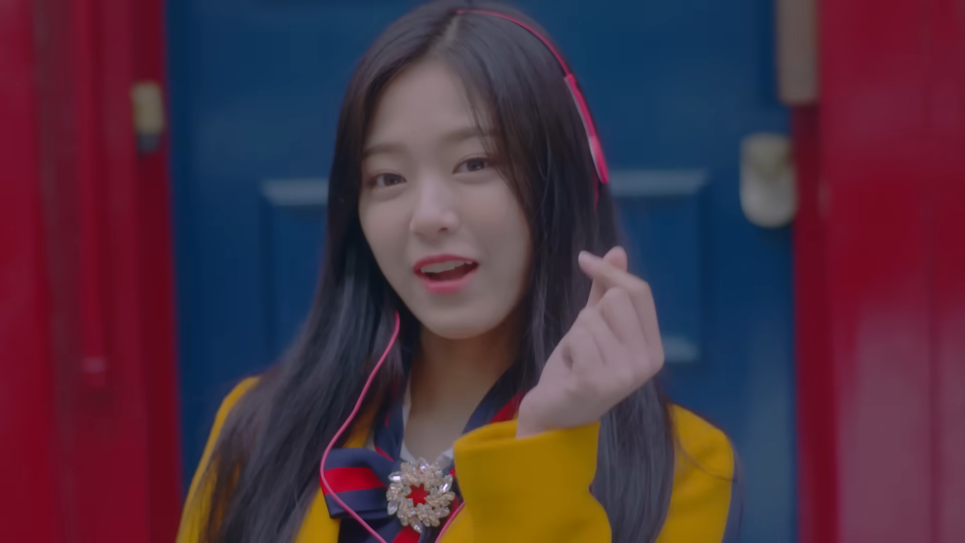 Hyunjin wearing pink headphones.